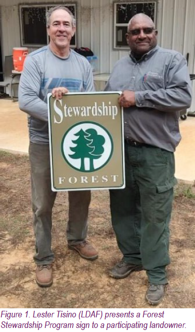 Figure 1. Lester Tisino (LDAF) presents a Forest Stewardship Program sign to a participating landowner.